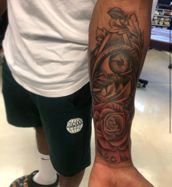 Arm tattoo of a flower and eye