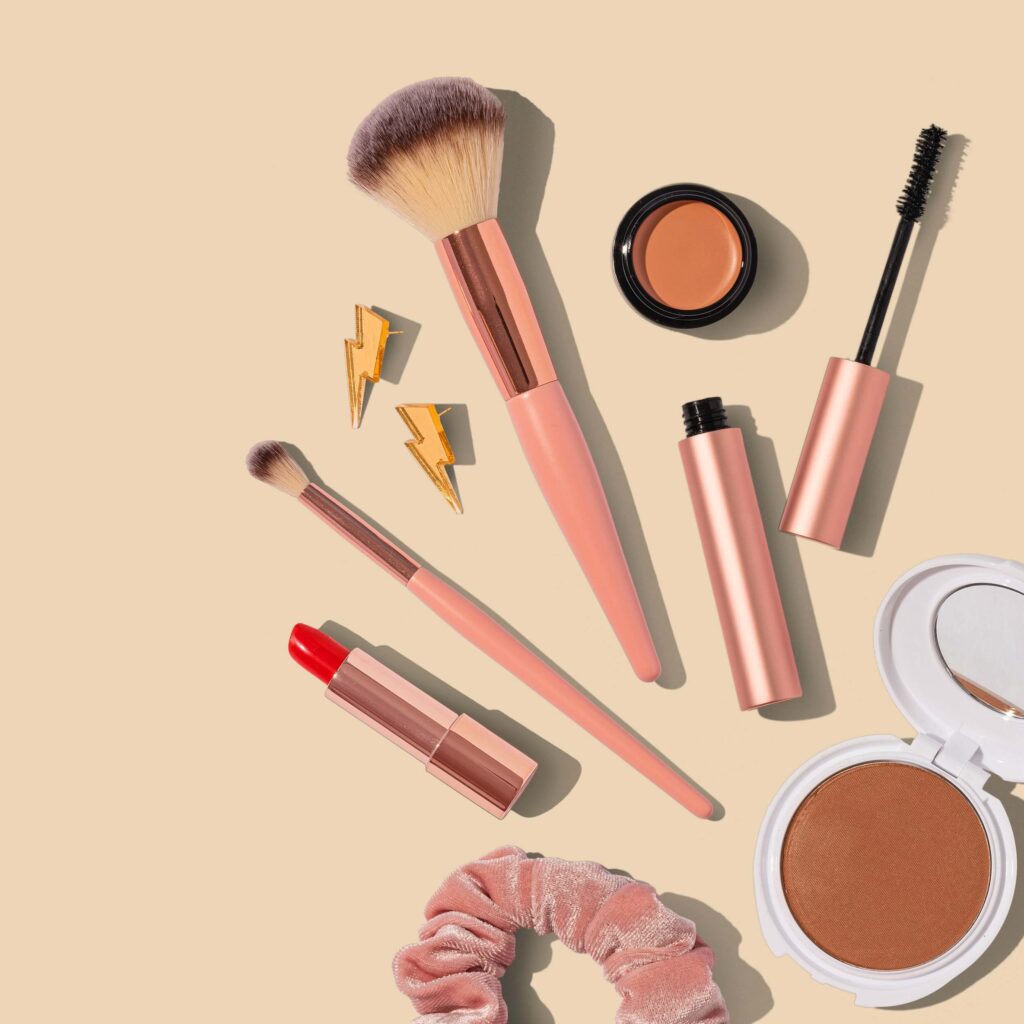 Makeup products and brushes laying a background